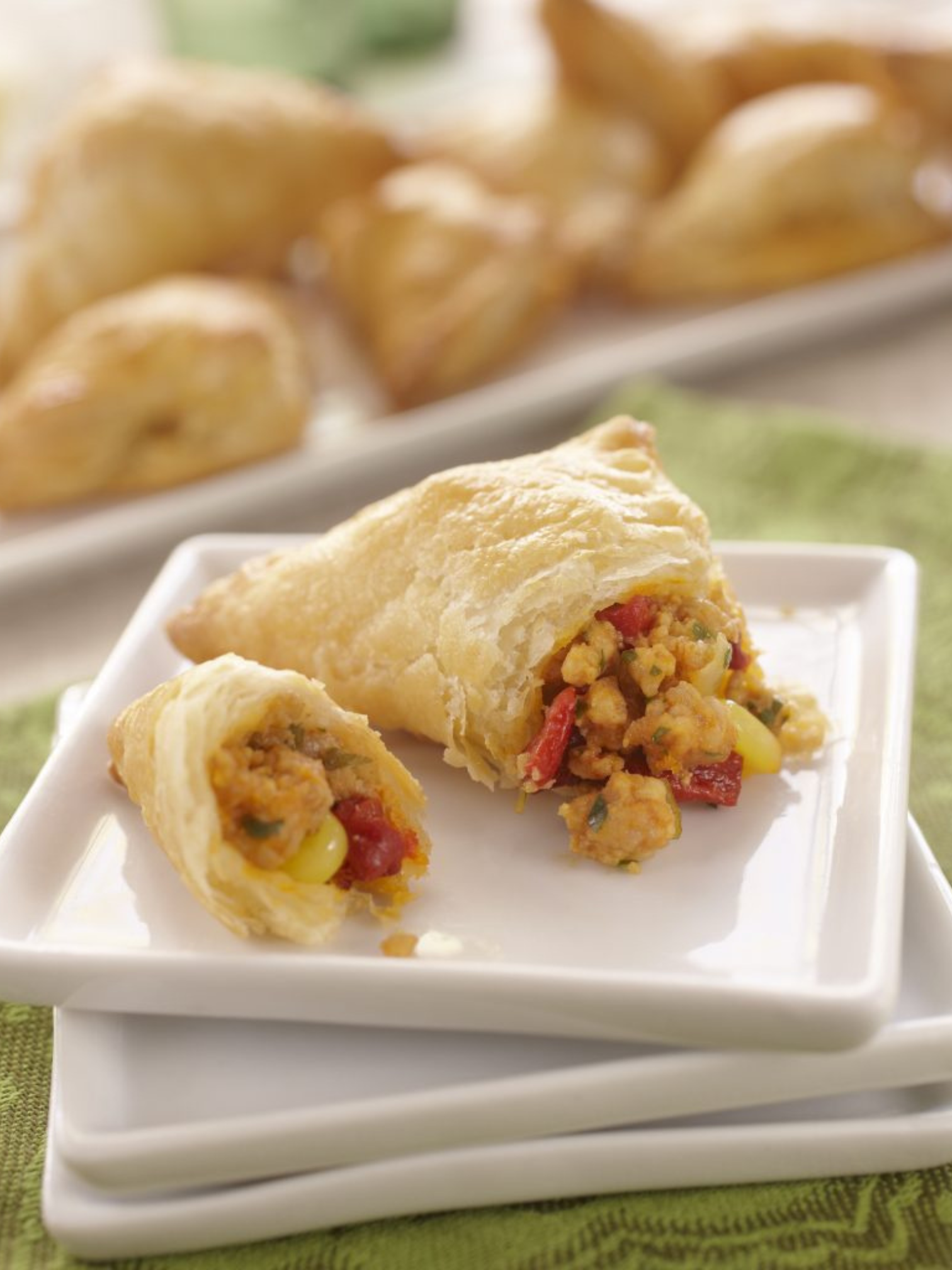 A thick cut veal loin chop resting on a pan of sauteed mushrooms.