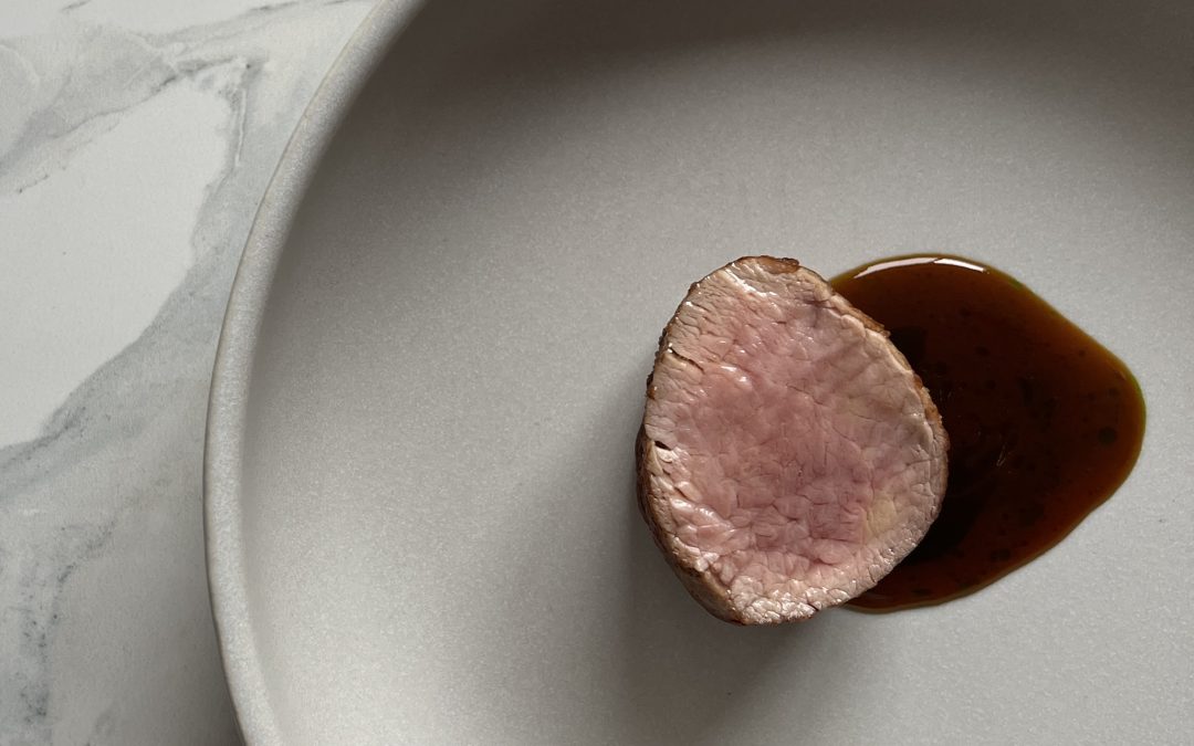 Pan Seared Veal Tenderloin with Tellicherry-scented Veal Jus split with a Wild Garlic Oil