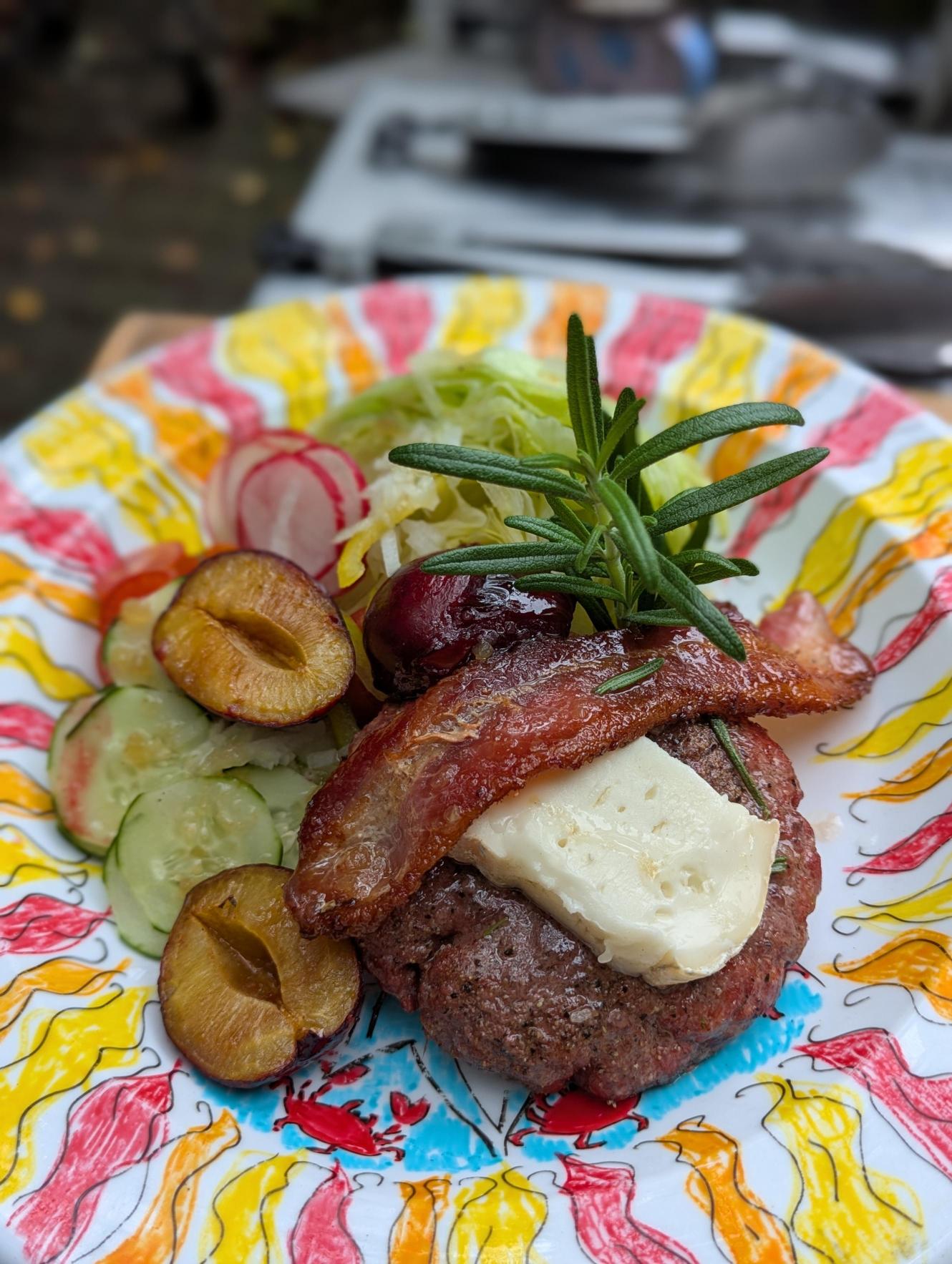 A thick cut veal loin chop resting on a pan of sauteed mushrooms.