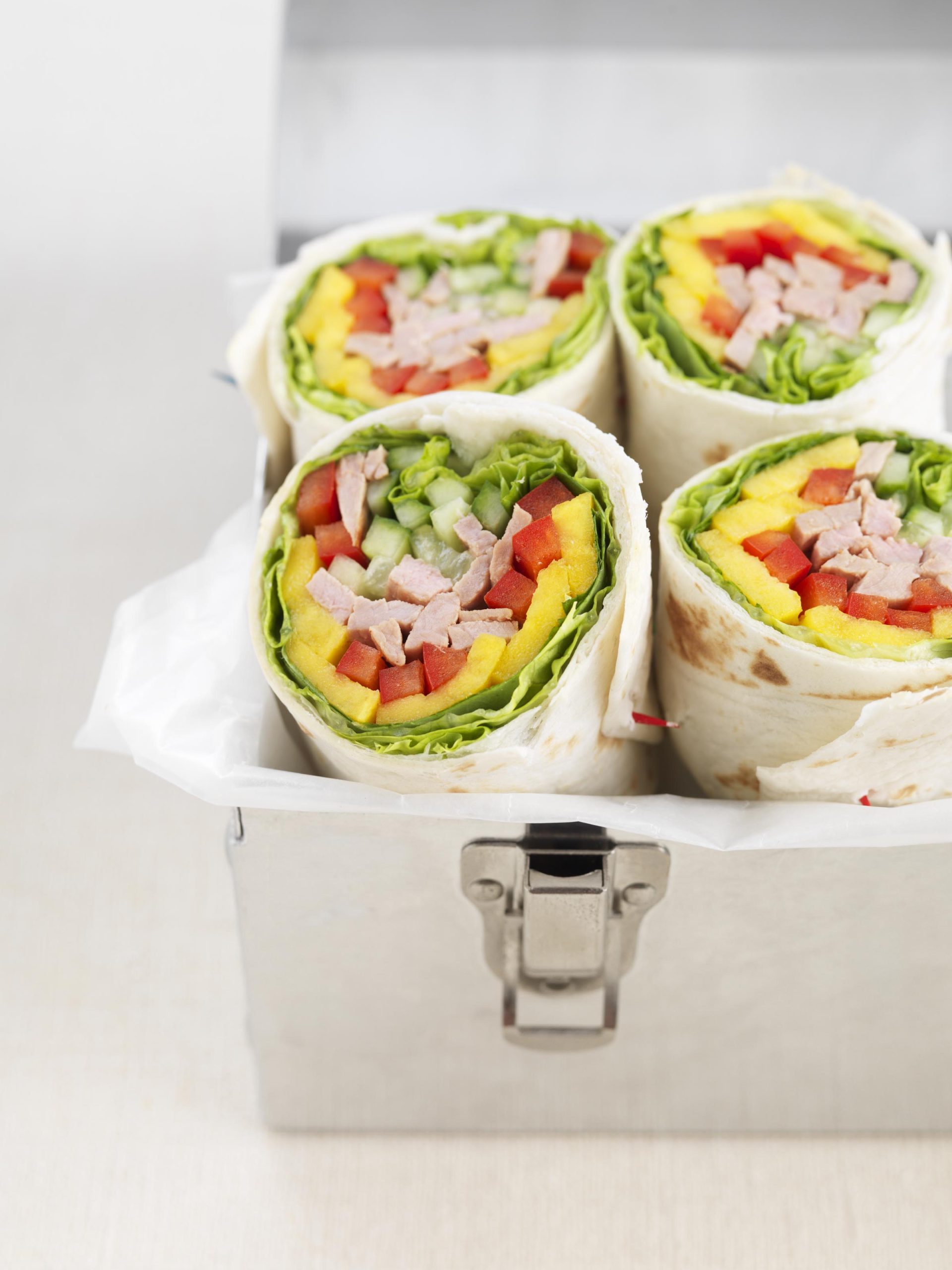 A thick cut veal loin chop resting on a pan of sauteed mushrooms.